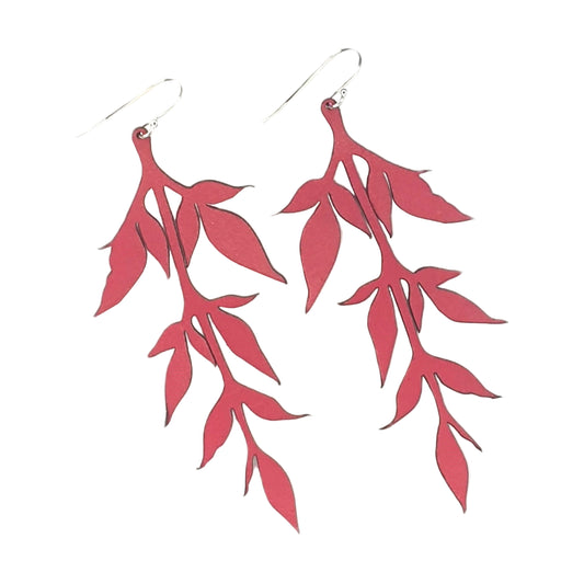 Red leaf-shaped earrings on a white background