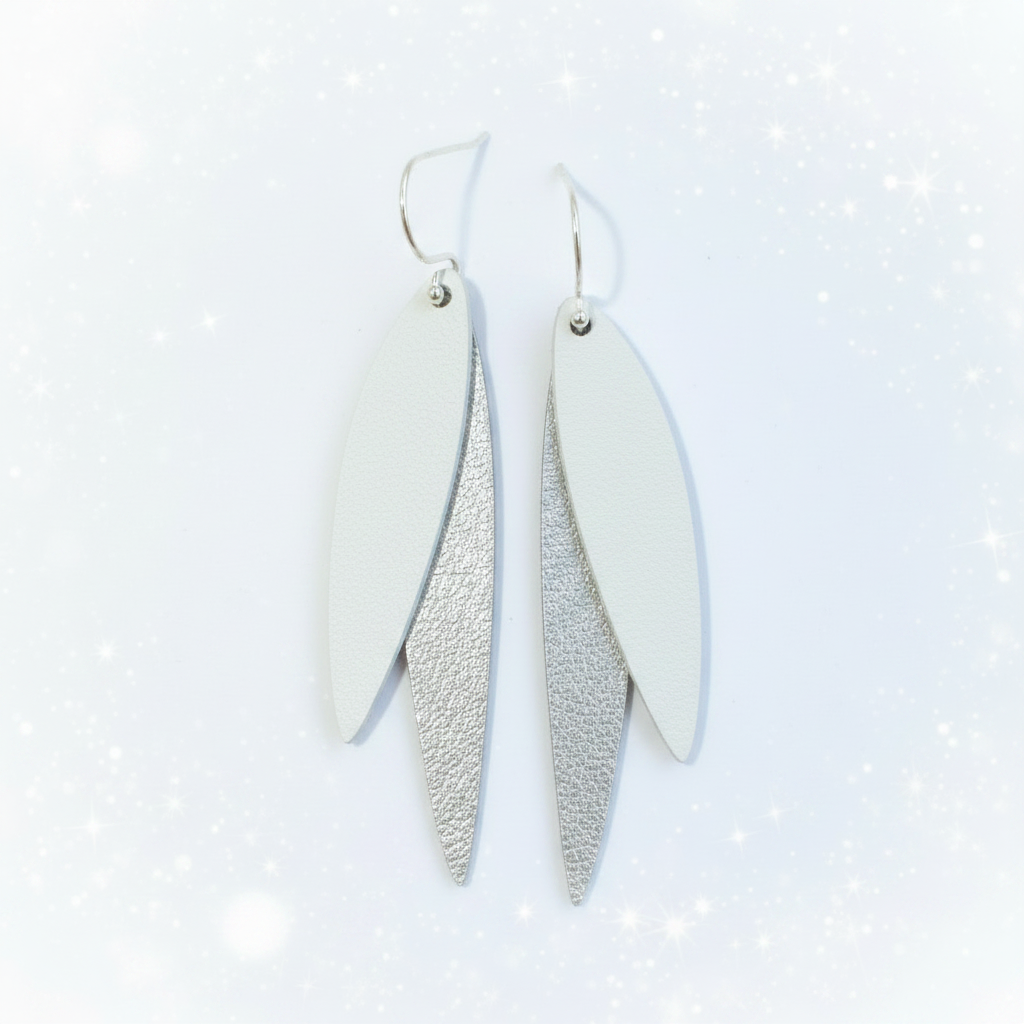 Silver and white earrings with sparkly star background