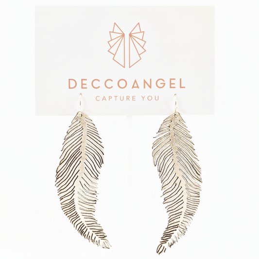Silver feather earrings with white background