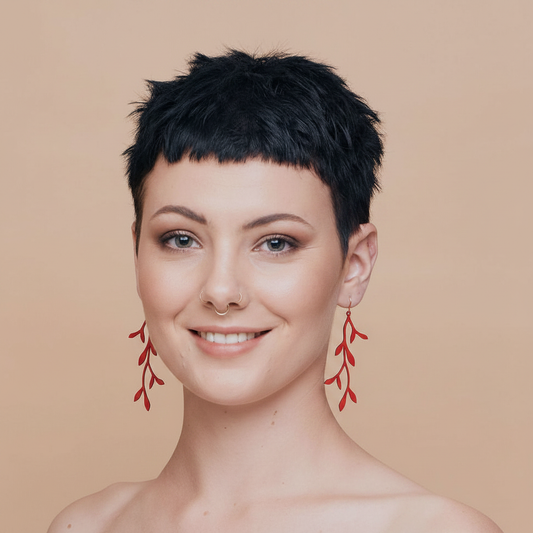 Smiling model with red leaf earrings